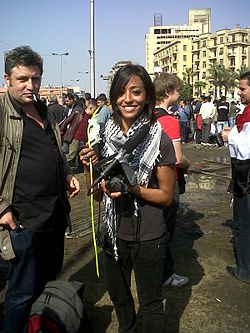 A female protester with her camera and a flower.jpg